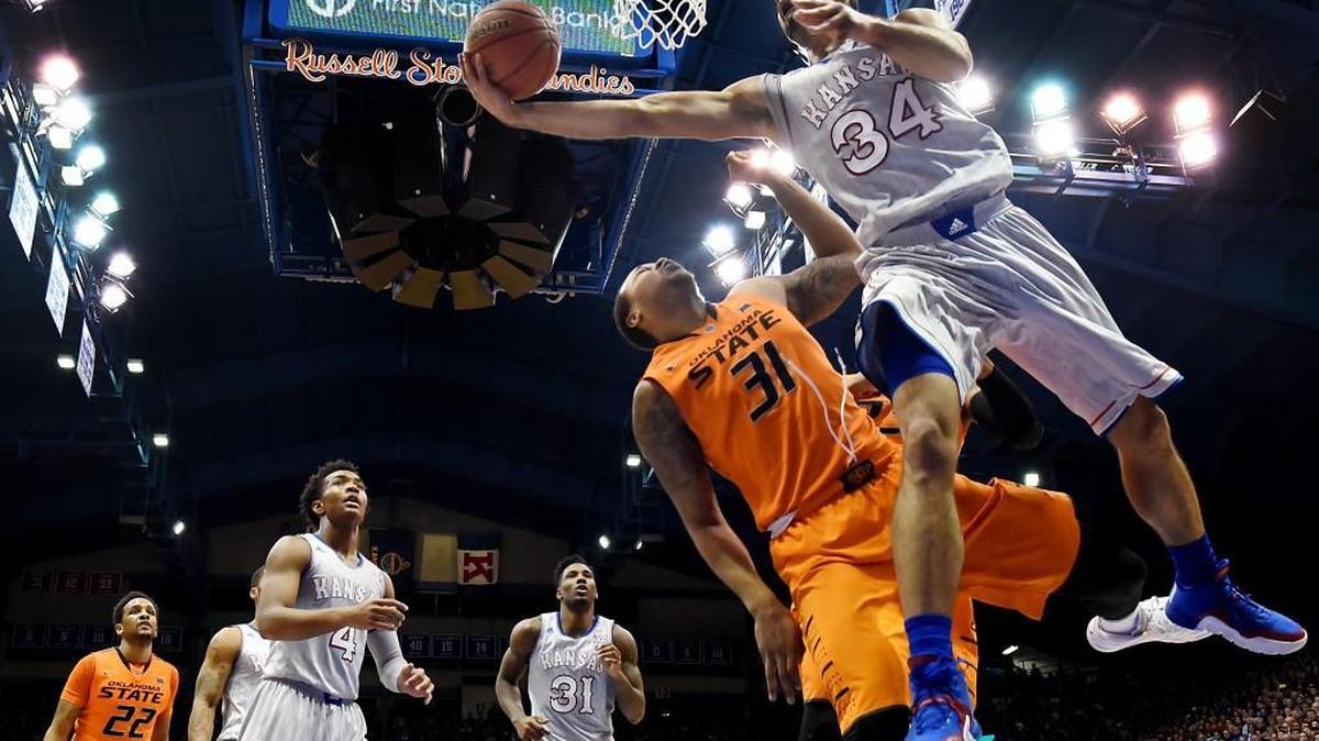 KU's Perry Ellis (34) sailed by OSU's Chris Olivier for the reverse during the second half of Monday night's game at Allen Fieldhouse. KU beat Oklahoma State, 94-67.
