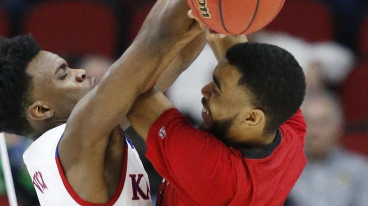 Kansas guard Lagerald Vick, left, blocks Austin Peay guard Josh Robinson as he tries to pass the ball Thursday afternoon. Vick had seven points in 10 minutes in his most productive game in some time.