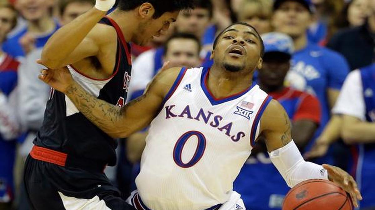 
Kansas’ Frank Mason III is pressured by Utah’s Chris Reyes during the first half Saturday at Sprint Center in Kansas City, Mo. 
