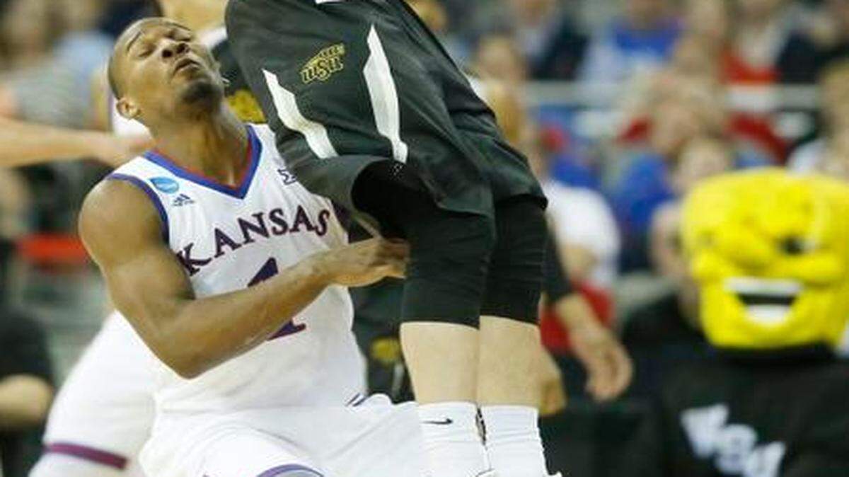 
Wichita State guard Ron Baker grabs a pass in front of Kansas guard Wayne Selden. Selden didn’t score and didn’t have an assist in Sunday’s loss to the Shockers.
