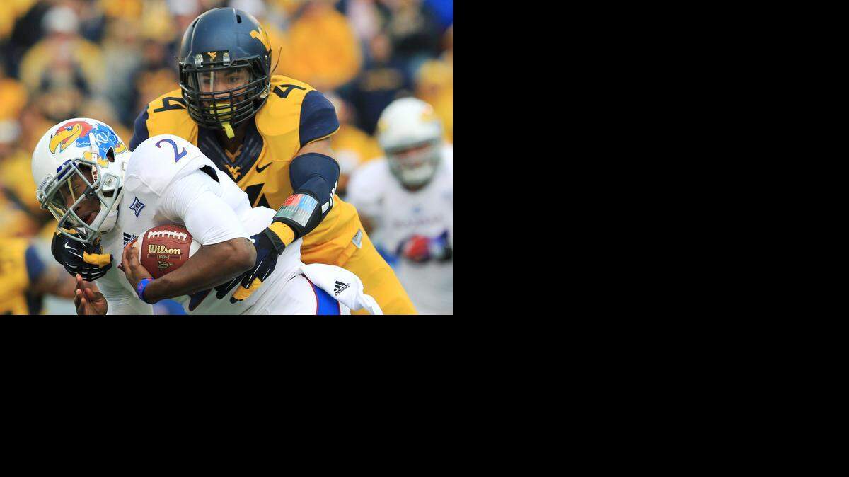 
Kansas quarterback Montell Cozart, left, was replaced at halftime of Saturday’s loss at West Virginia.
