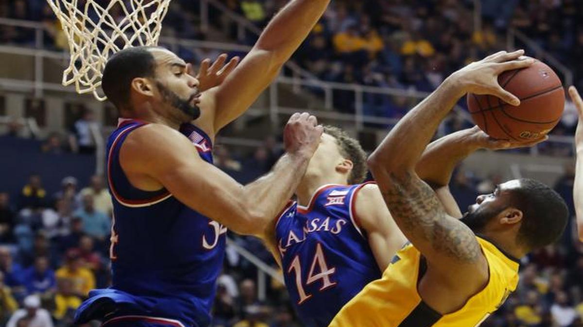 West Virginia guard Jaysean Paige (5) drove to the basket defended by Kansas forward Perry Ellis (34) when the Mountaineers beat the Jayhawks 74-63 on Jan. 12 in Morgantown, W.Va. On Tuesday night, the Mountaineers, now leading the Big 12, play the Jayhawks at Allen Fieldhouse in Lawrence.