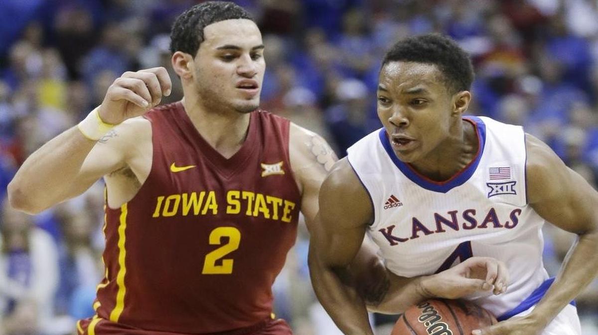
Kansas guard Devonte Graham, right, drives on Iowa State forward Abdel Nader during the Big 12 Tournament in Kansas City, Mo., in March. 
