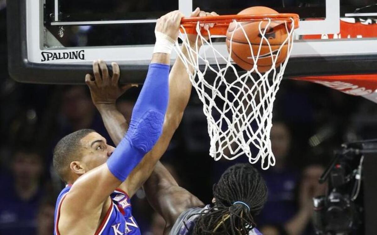 Kansas post player Landen Lucas dunks over K-State’s D.J. Johnson on Monday night in Manhattan.