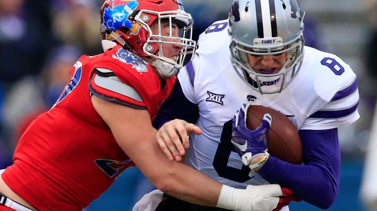 Kansas’ Joe Dineen, left, tackles K-State quarterback Joe Hubener last season. Dineen has been battling a hamstring injury and Tuesday was ruled out of the rest of the season.