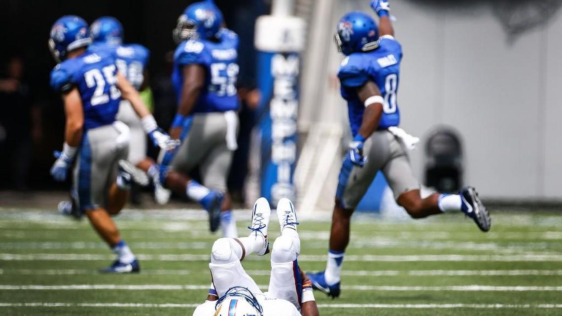 Kansas quarterback Montell Cozart lays on the field after throwing an interception for a touchdown against Memphis during the second quarter last Saturday.