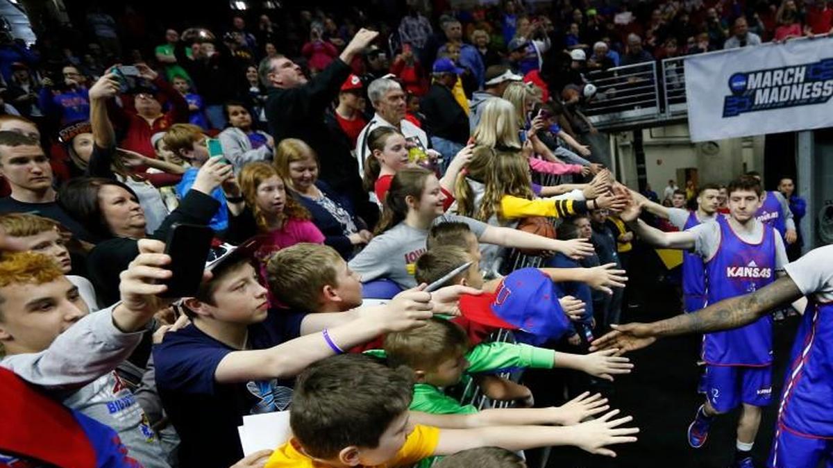 Kansas forward Jamari Traylor meets the fans as he takes the court Wednesday afternoon for Kansas’ public practice at Wells Fargo Arena in Des Moines.