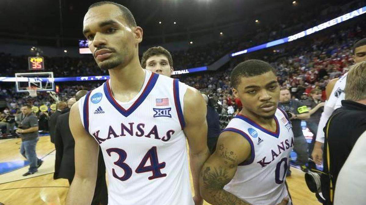 
Kansas forward Perry Ellis and guard Frank Mason leave the court after the Jayhawks fell to Wichita State 78-65 on Sunday in Omaha.
