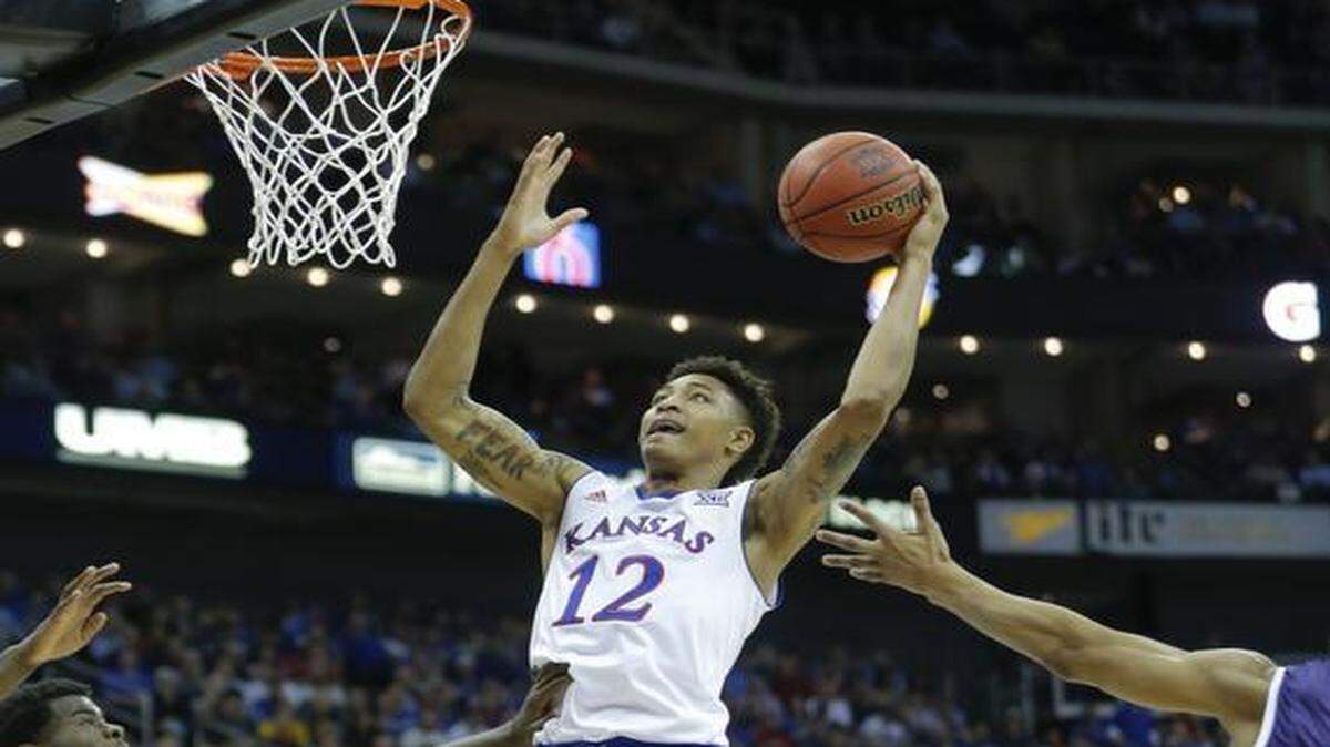
Kansas' Kelly Oubre grabs a rebound and puts it back for a basket against TCU during the first half of their Big 12 quarterfinal game Thursday in Kansas City.
