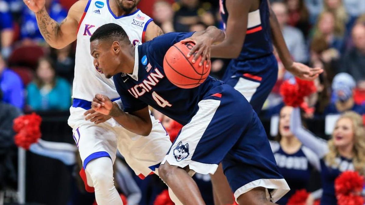 Connecticut's Sterling Gibbs (4) tries to drive past Kansas’ Frank Mason on Saturday night in Des Moines. Kansas won 73-61 to advance to the South Regional semifinals.