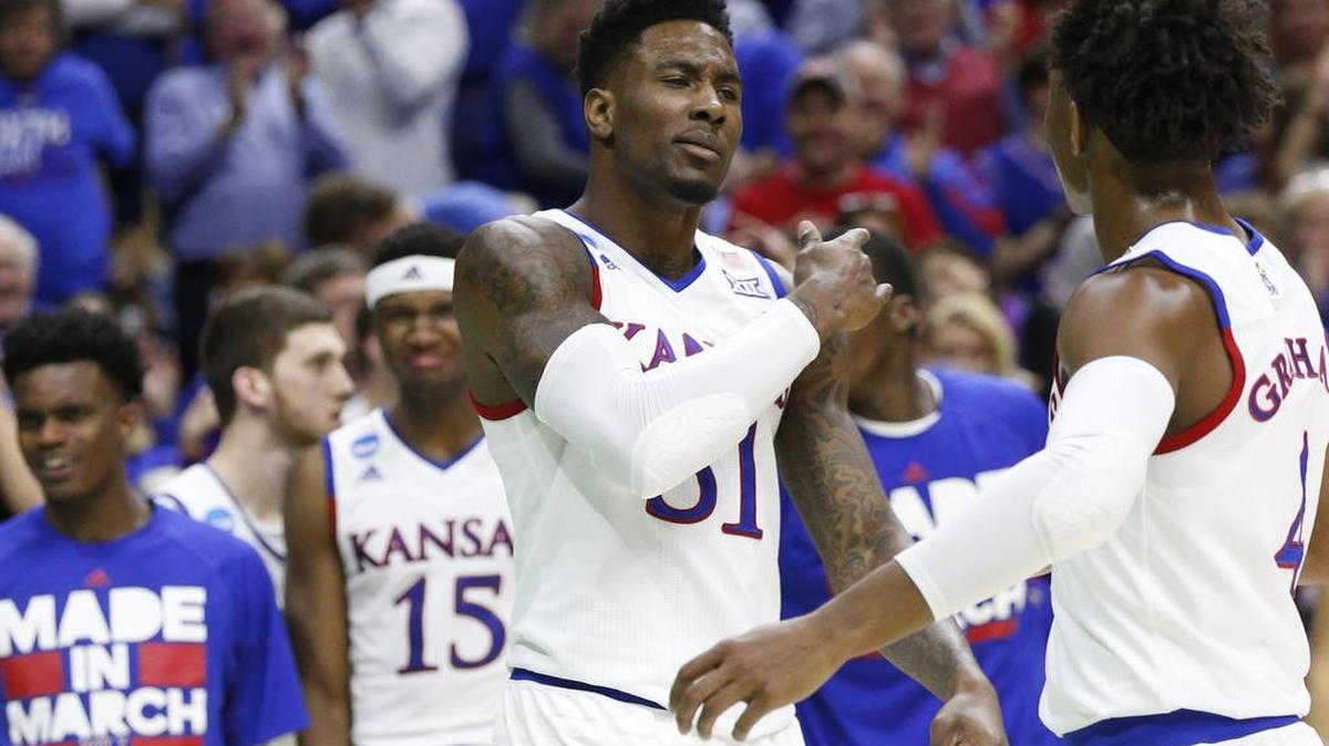 Former Kansas forward Jamari Traylor, center, is likely headed overseas to begin playing professional basketball, though he hopes to get workouts with NBA teams.
