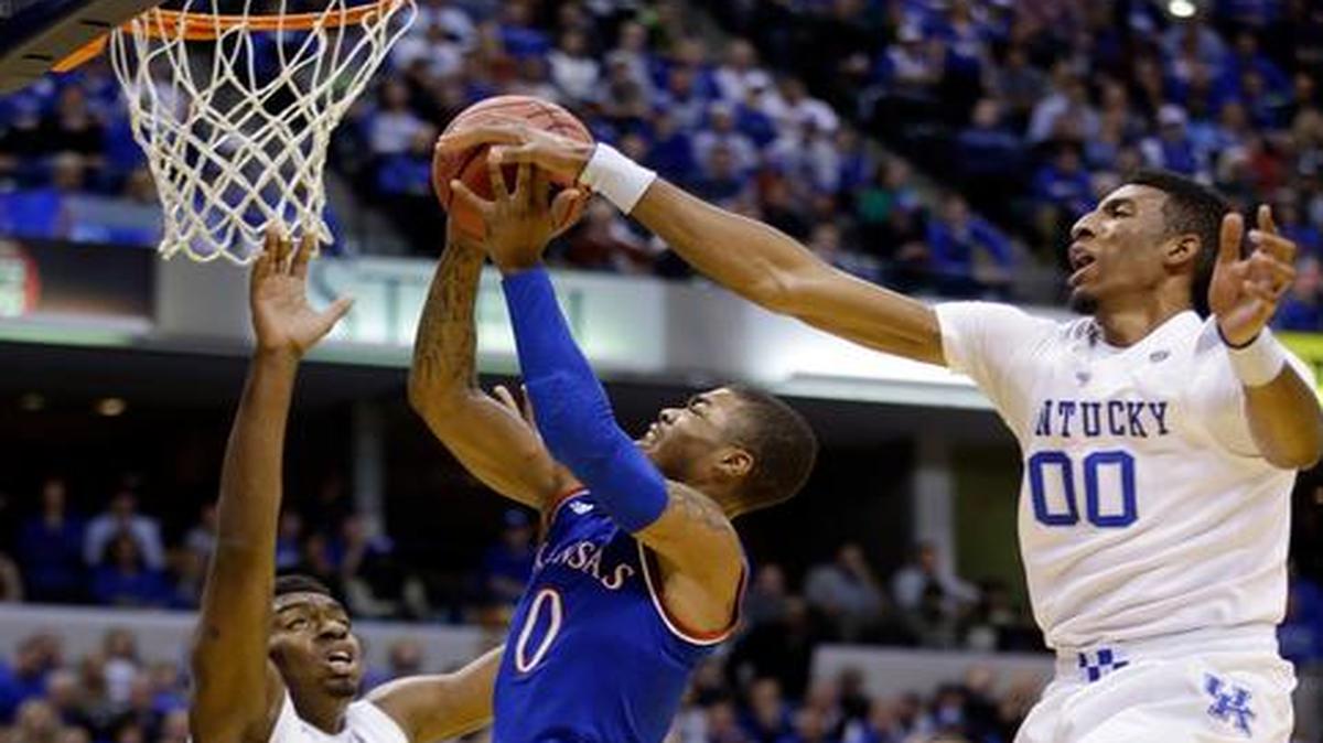 
Kansas's Frank Mason III has his shot blocked by Kentucky's Marcus Lee (00) during the first half of Tuesday’s game in Indianapolis. 
