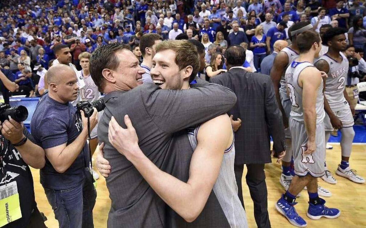 Kansas senior Tyler Self hugs his father, coach Bill Self, after the Jayhawks clinched at least a tie for their 13th consecutive Big 12 Conference title with a win over TCU last Wednesday at Allen Fieldhouse.