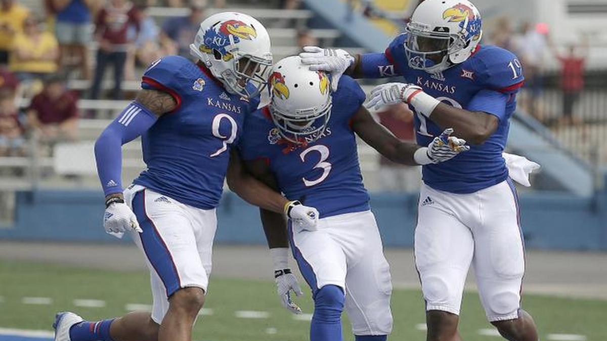 
Kansas wide receiver Tony Pierson, middle, celebrates with Nigel King, left, and Justin McCay after Pierson scored a touchdown against Central Michigan on the team’s first play from scrimmage Saturday in Lawrence.
