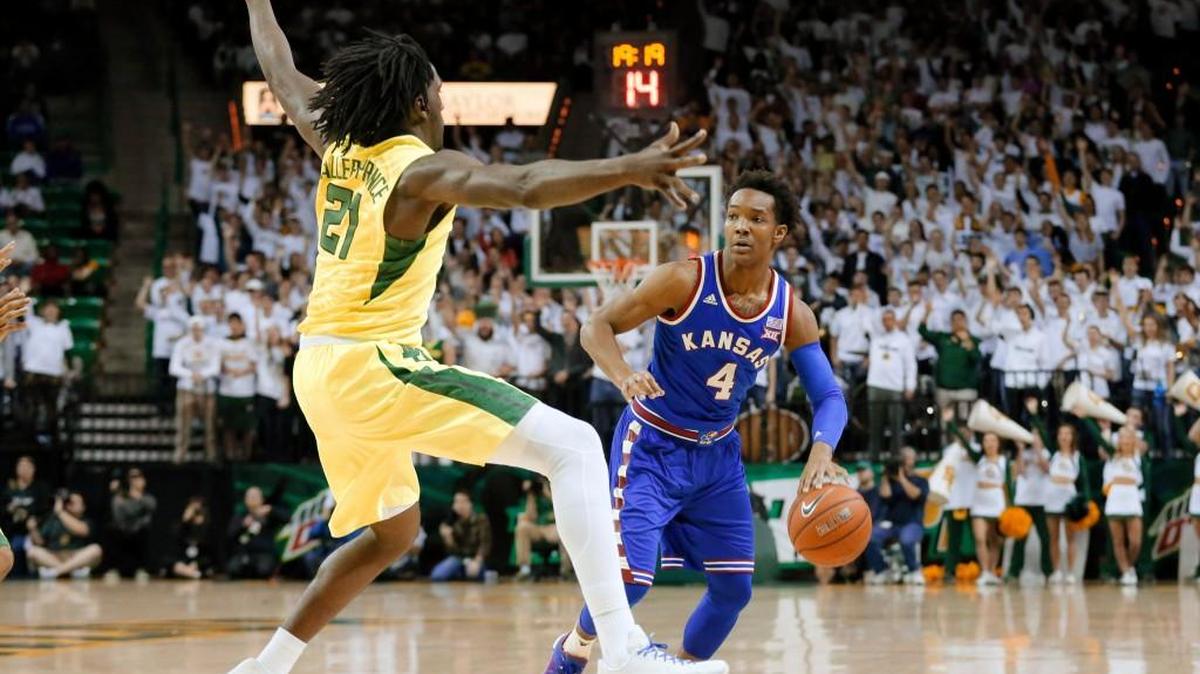 Baylor's Taurean Prince (21) defends as Kansas guard Devonte' Graham (4) handles the ball on Tuesday night.