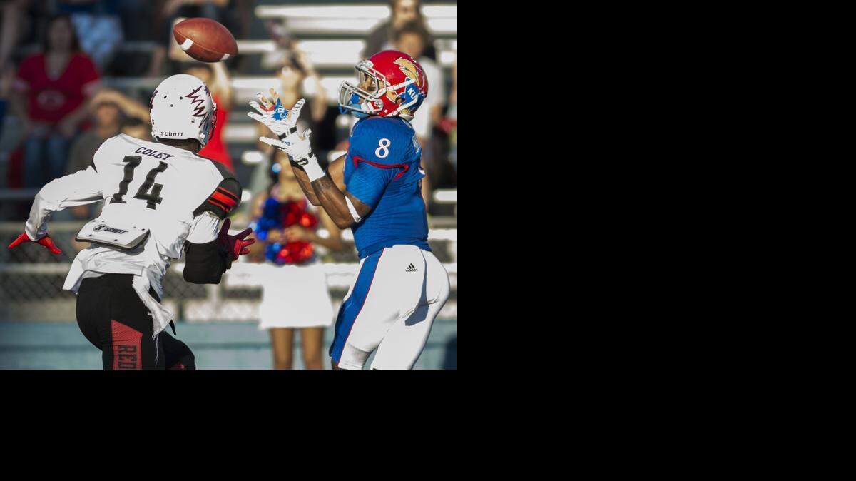 
Southeast Missouri State Redhawks safety David Coley (14) watches as Kansas Jayhawks wide receiver Nick Harwell (8) collects a pass for a touchdown in the first quarter.
