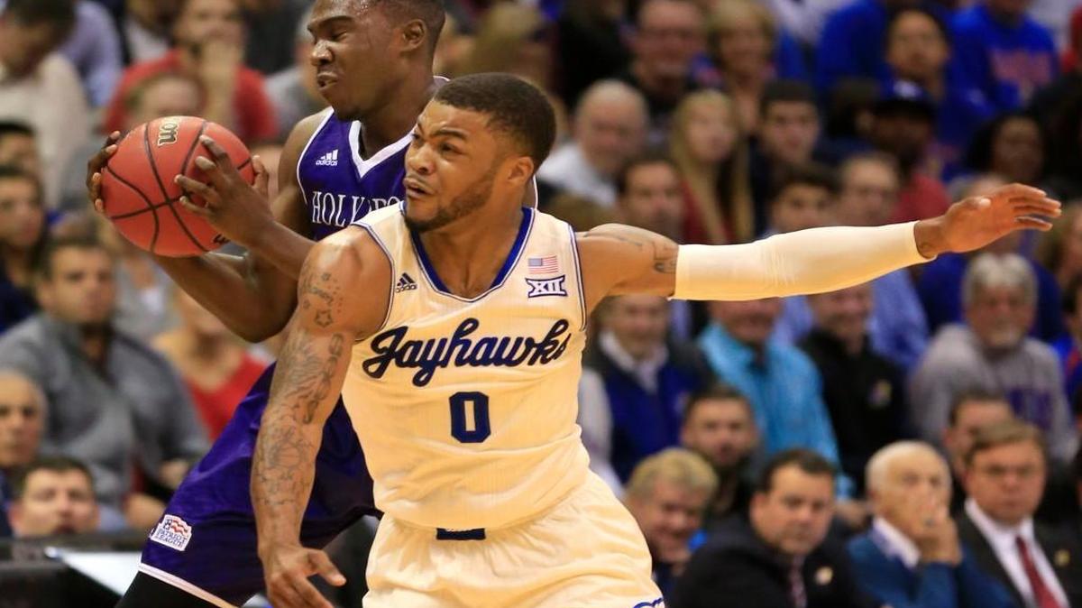Kansas guard Frank Mason tries to steal the ball from Holy Cross forward Karl Charles during the first half Wednesday in Lawrence.