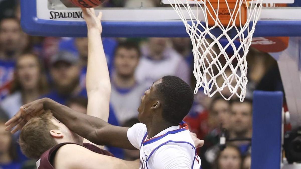 Kansas forward Cheick Diallo fouls Montana center Bryden Boehning during the first half Saturday at Allen Fieldhouse.