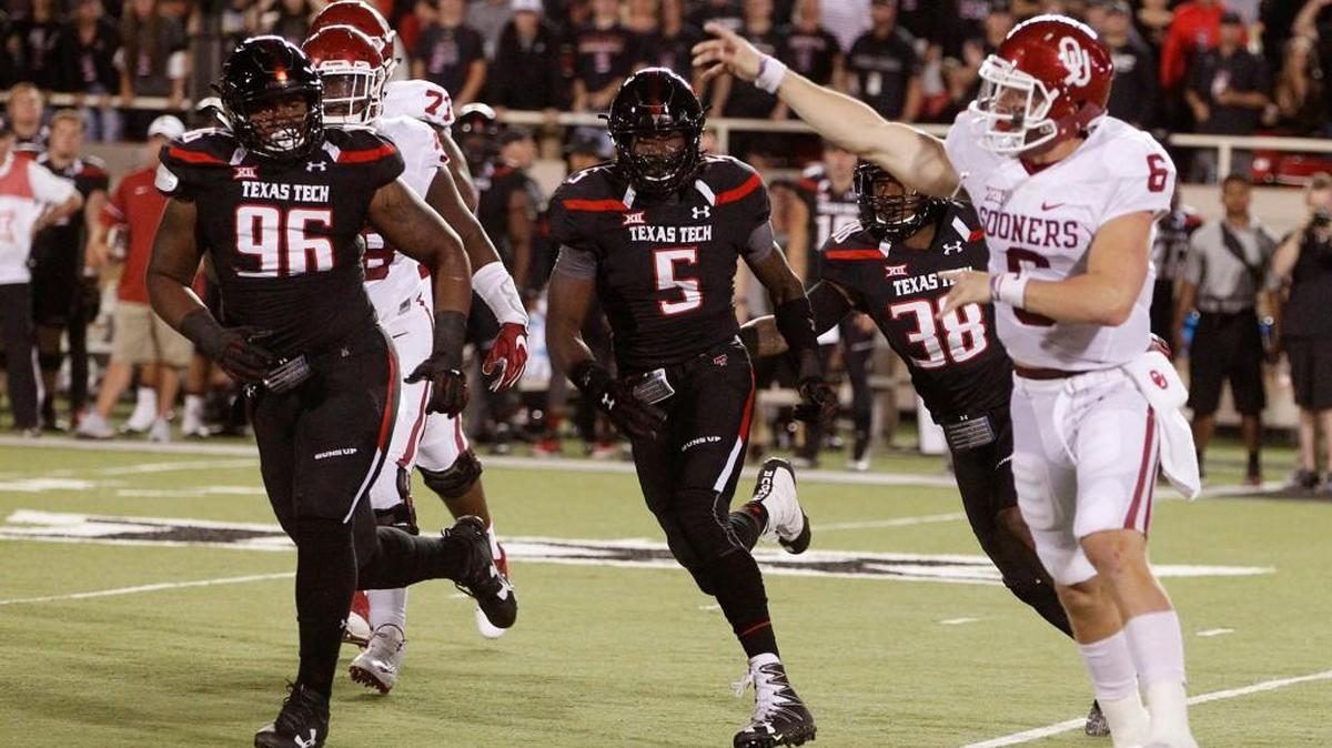 Oklahoma's quarterback Baker Mayfield passes under heavy pursuit by Texas Tech last Saturday in Lubbock, Texas.