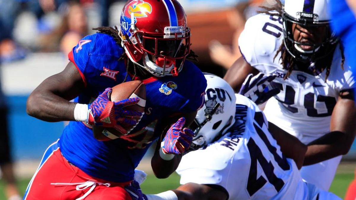 Kansas running back Taylor Martin gets past TCU defensive end James McFarland for a first-half touchdown Saturday in Lawrence.