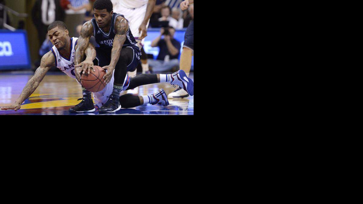 
KU’s Frank Mason (left) battled Washburn’s Kevin House for a loose ball during the second half of an exhibition game at Allen Fieldhouse.
