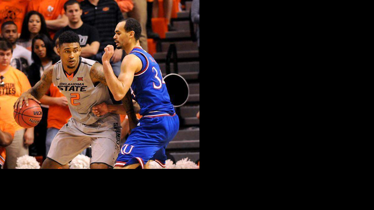 
Kansas forward Ellis Perry (right) defended against Oklahoma State guard Le’Bryan Nash on Saturday in Stillwater, Okla. Nash led Oklahoma State scoring with 18 points in the 67-62 win over Kansas. 

