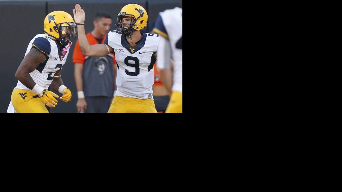 
West Virginia quarterback Clint Trickett congratulates Heights product Dreamius Smith after a touchdown Saturday at Oklahoma State.

