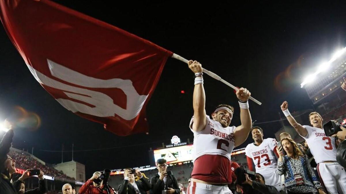 Oklahoma quarterback Baker Mayfield waves the school flag following a 31-16 win against Ohio State at Ohio Stadium in Columbus, Ohio, on Saturday, Sept. 9, 2017. (Adam Cairns/Columbus Dispatch/TNS)