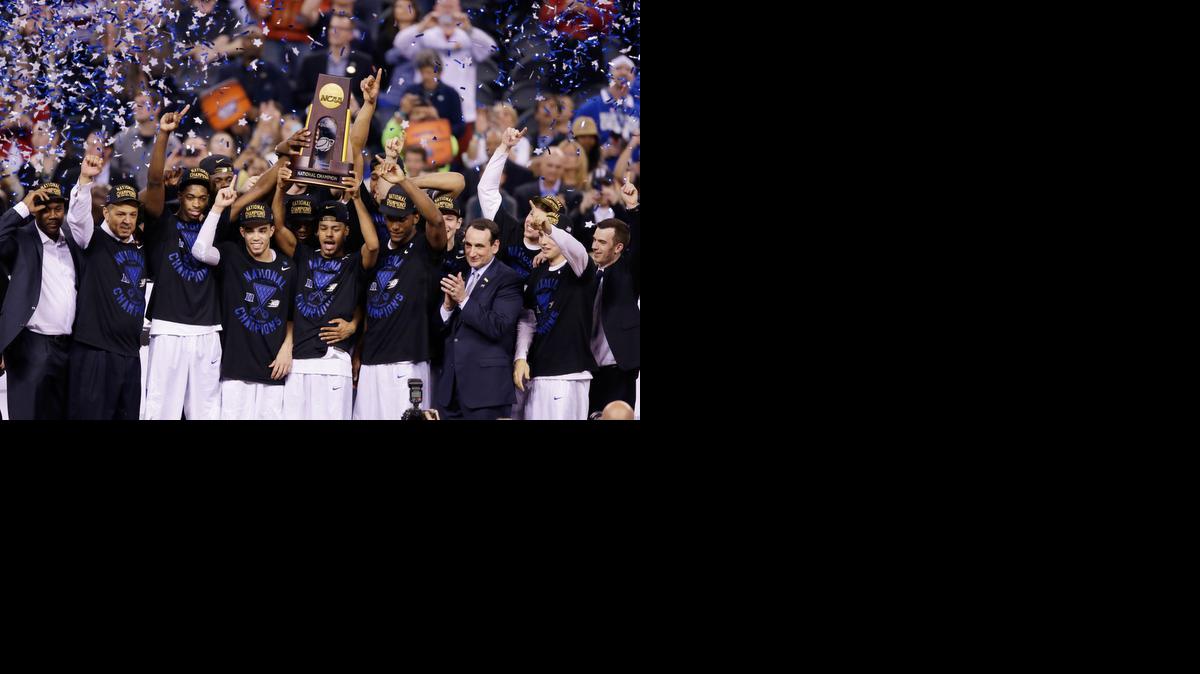 
Duke players celebrate with the trophy after their 68-63 victory over Wisconsin in the NCAA Final Four college basketball tournament championship game Monday, April 6, 2015, in Indianapolis.
