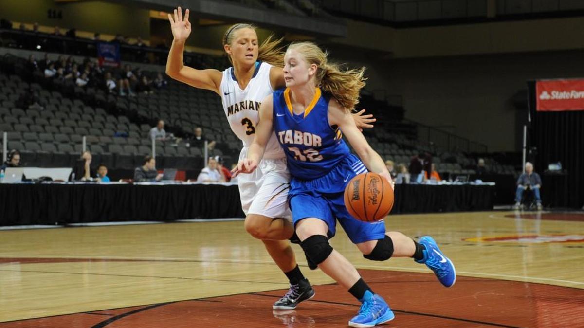 Tabor College forward Tena Loewen takes the ball to the basket against Marian during the NAIA Division II Tournament in March.