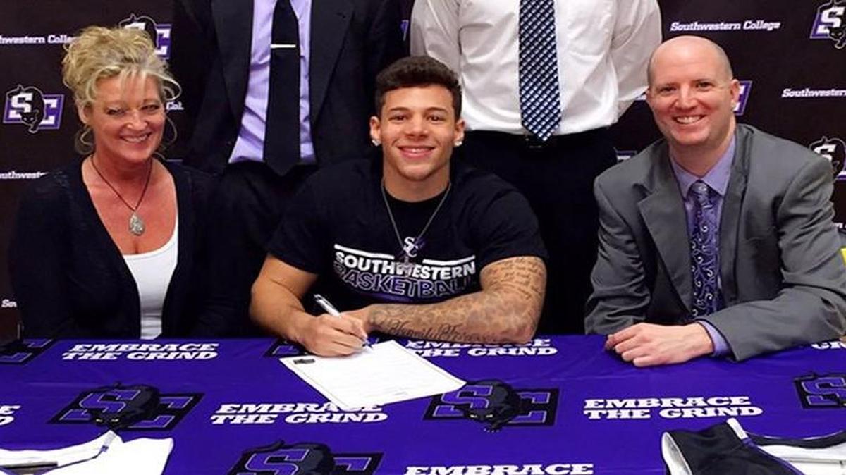 With his mother Gina Evans looking on, former Eisenhower star Trevon Evans, middle, signed with Southwestern College and coach Matt O’Brien, right, in December but decided to leave last week and will play for Dodge City Community College next season.