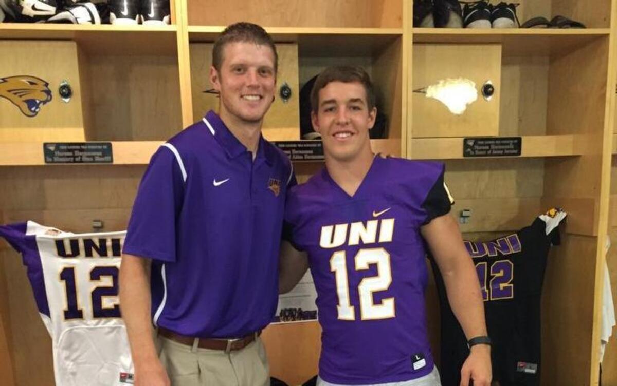 Wichita native Colton Howell, right, stands with Northern Iowa quarterbacks coach Collin Klein in UNI’s locker room last month. Howell announced Friday he will leave Butler Community College and transfer to UNI for his final three seasons of eligibility.