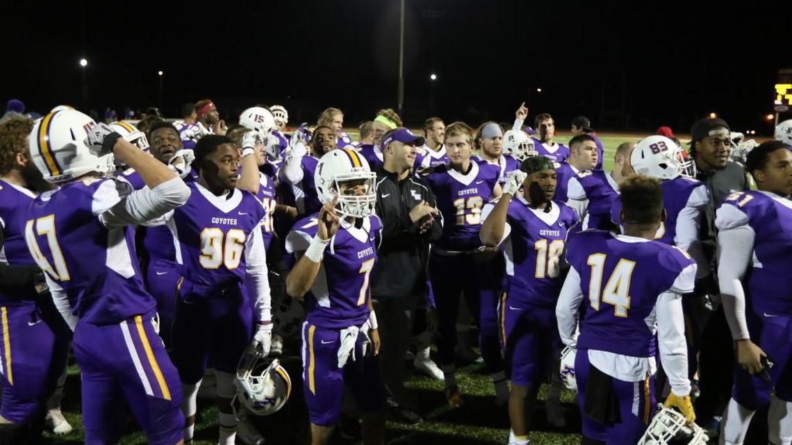 Kansas Wesleyan football coach Matt Drinkall, center, celebrates a win with his team in Salina this season. Drinkall has led the Coyotes to the NAIA playoffs in his second year.