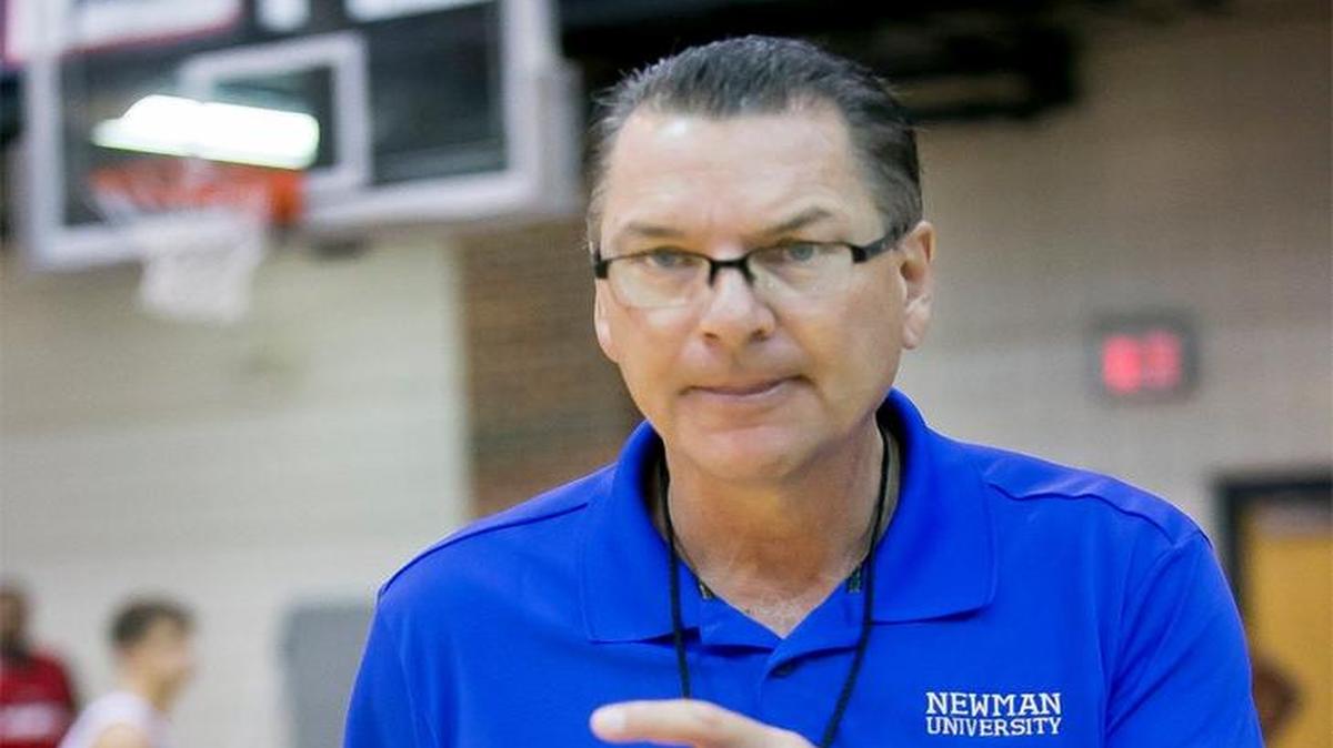 Newman basketball coach Mark Potter works with his team during a practice before the season.