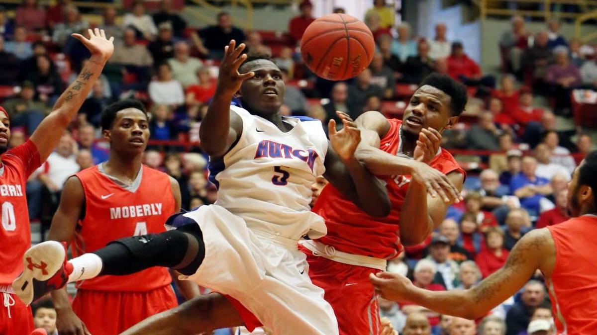 Hutchinson's Bashir Ahmed, left, and Moberly’s Cecil Williams grab for a rebound during the second half of Wednesdya’s quarterfinal game in Hutchinson.