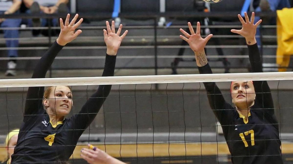 Katy Dudzinski, left, and Shimen Fayad of WSU deflect a Northern Iowa spike.