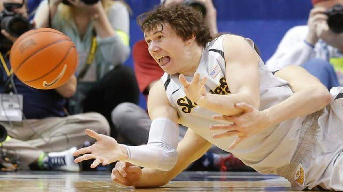 
Wichita State’s Evan Wessel throws the ball to a teammate from the ground during Friday’s game against Southern Illinois. Wessel, like many of his teammates, returned home from St. Louis with bumps and bruises.
