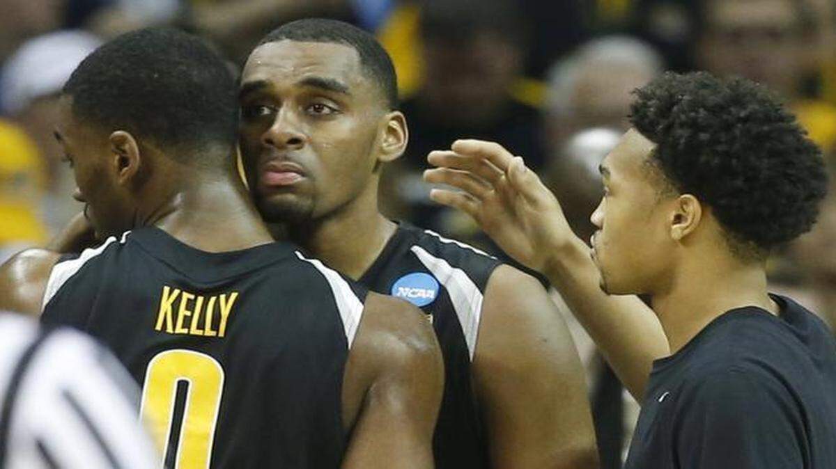 
Wichita State forward Darius Carter hugs teammate Rashard Kelly and gets a pat on the back from Corey Henderson in the final seconds against Notre Dame in the Midwest Regional semifinal of the NCAA Tournament at Quicken Loans Arena in Cleveland.
