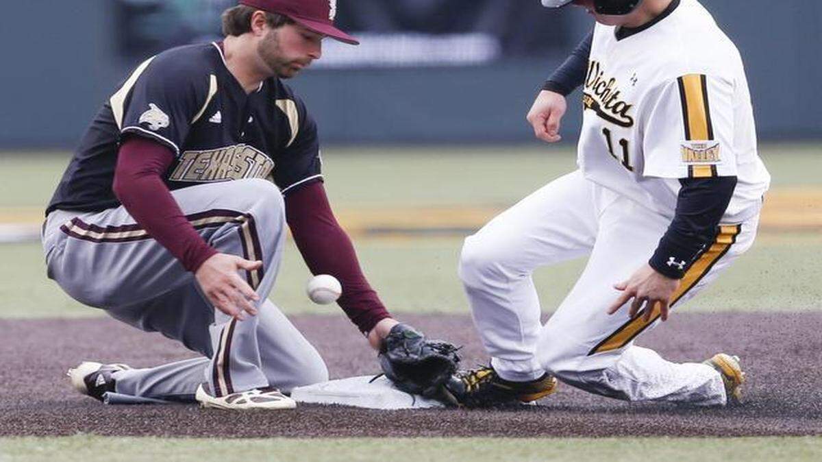 
Wichita State's Michael Burns steals decond base as Texas State's Cedric Vallieres can't hang on to the ball in the during the second game of Friday’s doubleheader at Eck Stadium. 
