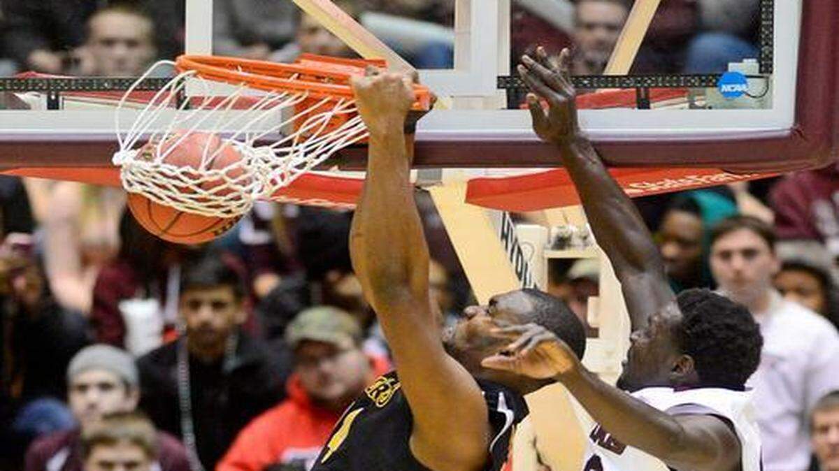 
Wichita State forward Shaquille Morris dunks as Southern Illinois center Ibby Djimde tries to defend in the first half Tuesday at SIU Arena. The Shockers won 84-62.
