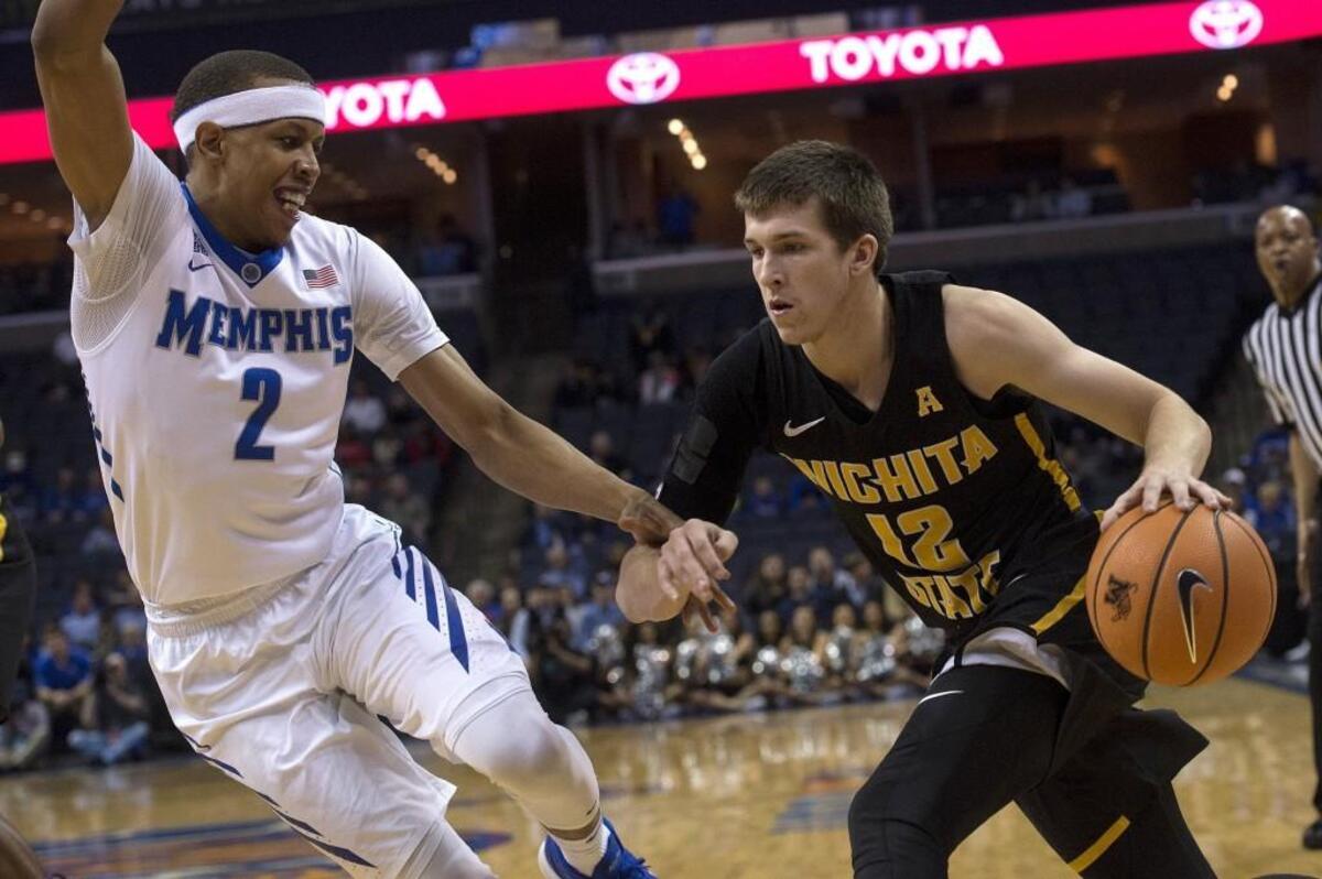 Wichita State guard Austin Reaves (12) drives against Memphis forward Jimario Rivers (2) during the first half of an NCAA college basketball game Tuesday, Feb. 6, 2018, in Memphis, Tenn. (AP Photo/Brandon Dill)