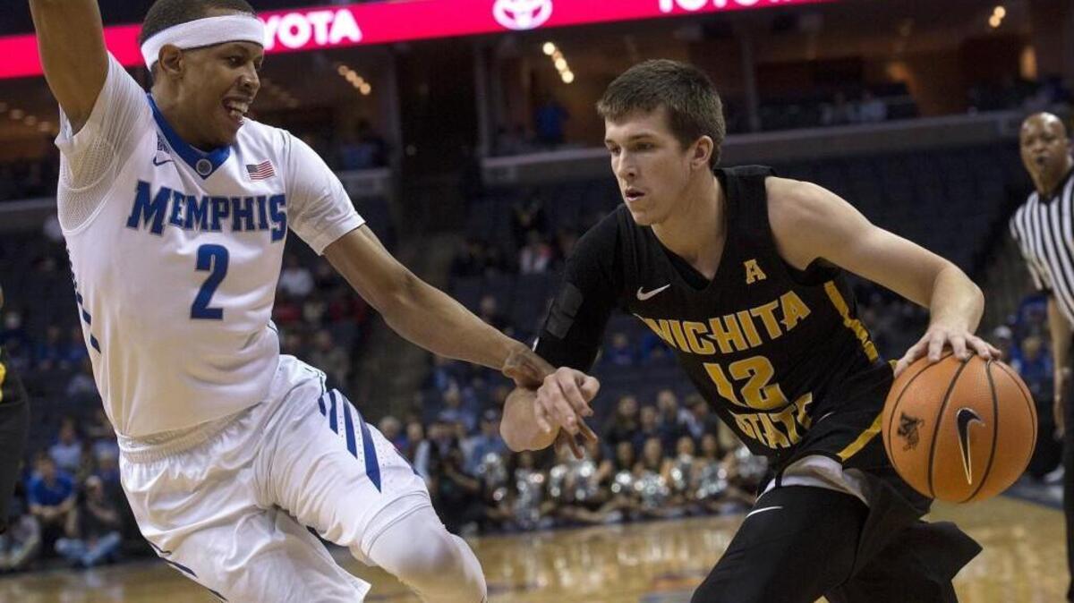 Wichita State guard Austin Reaves (12) drives against Memphis forward Jimario Rivers (2) during the first half of an NCAA college basketball game Tuesday, Feb. 6, 2018, in Memphis, Tenn. (AP Photo/Brandon Dill)