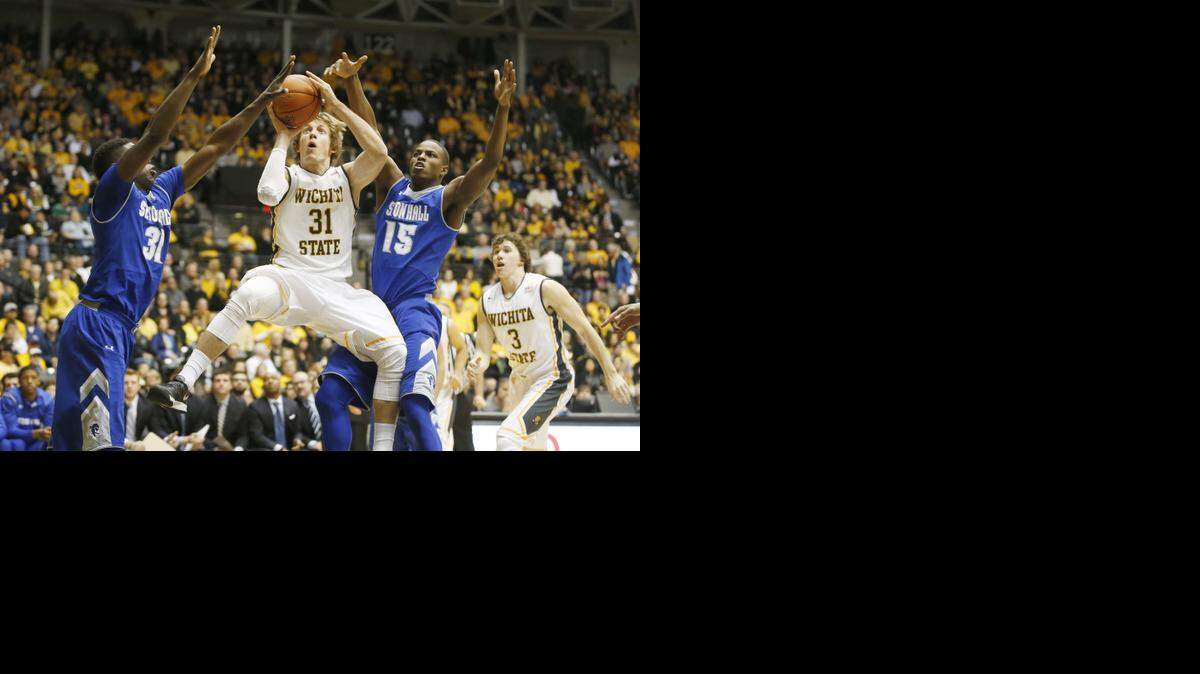 
Wichita State's Ron Baker shoots between Seton Hall's Angel Delgado (31) and Isaiah Whitehead in December.
