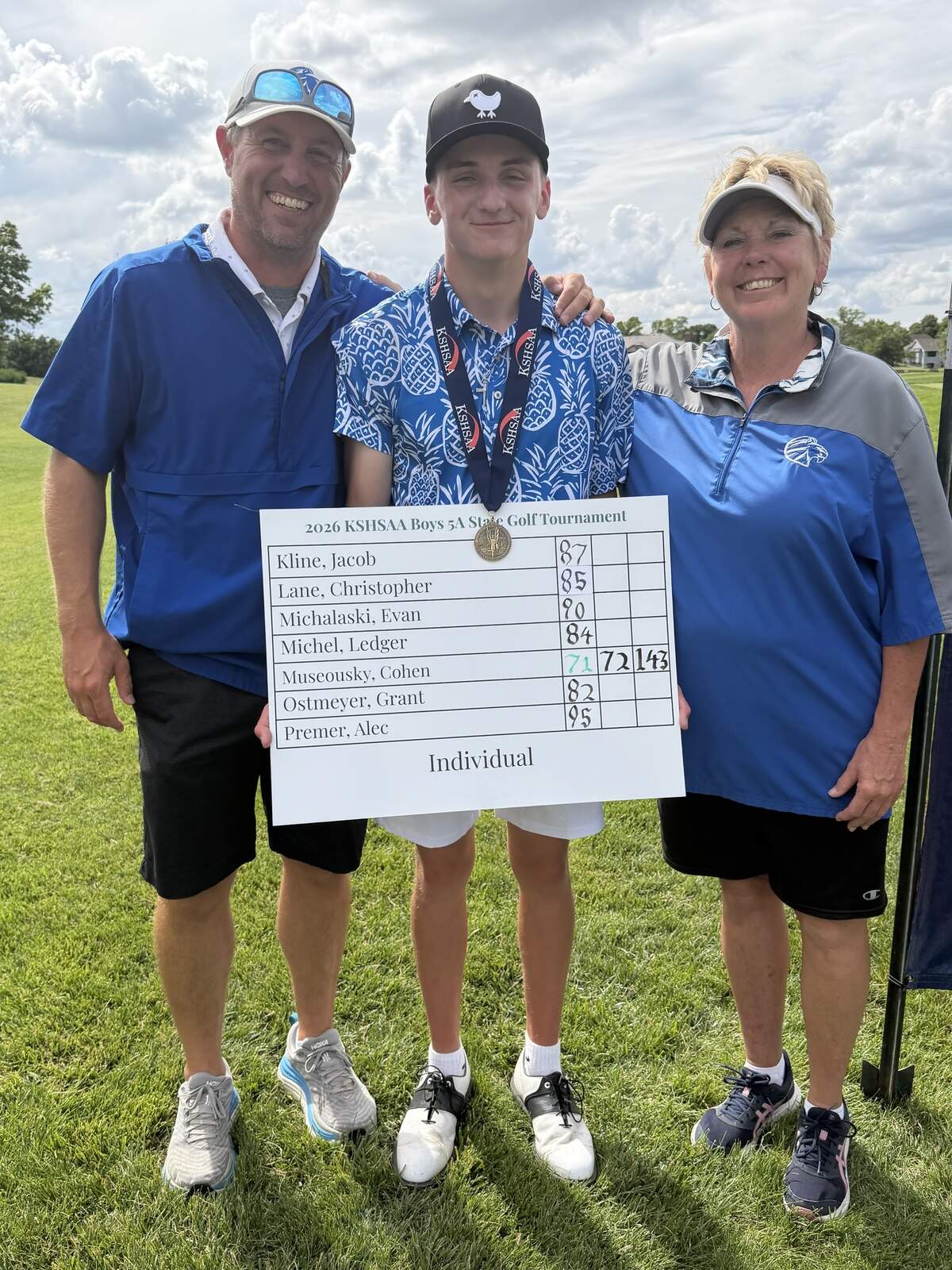 Goddard sophmore Cohen Museousky takes a picture with head coach Jim Zimmer and assistant Rita Smith after becoming the school’s first state championship golfer.