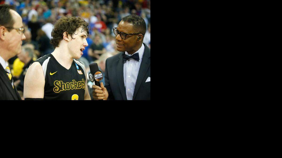 
Wichita State junior Evan Wessel talks with CBS’ Lewis Johnson, with WSU coach Gregg Marshall watching, after Sunday’s victory over Kansas in Omaha.
