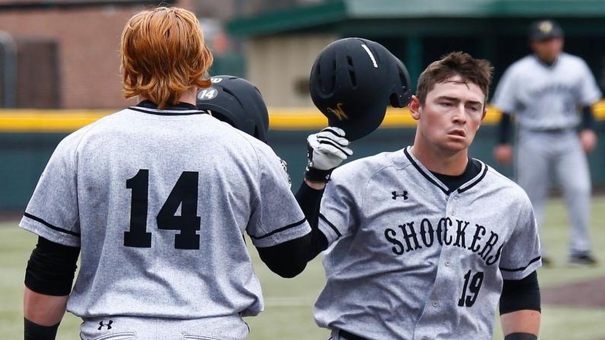 Wichita State’s Gunnar Troutwine, left, greets Luke Ritter after Troutwine’s home run against Utah Valley last month during the first weekend of the season at Eck Stadium.