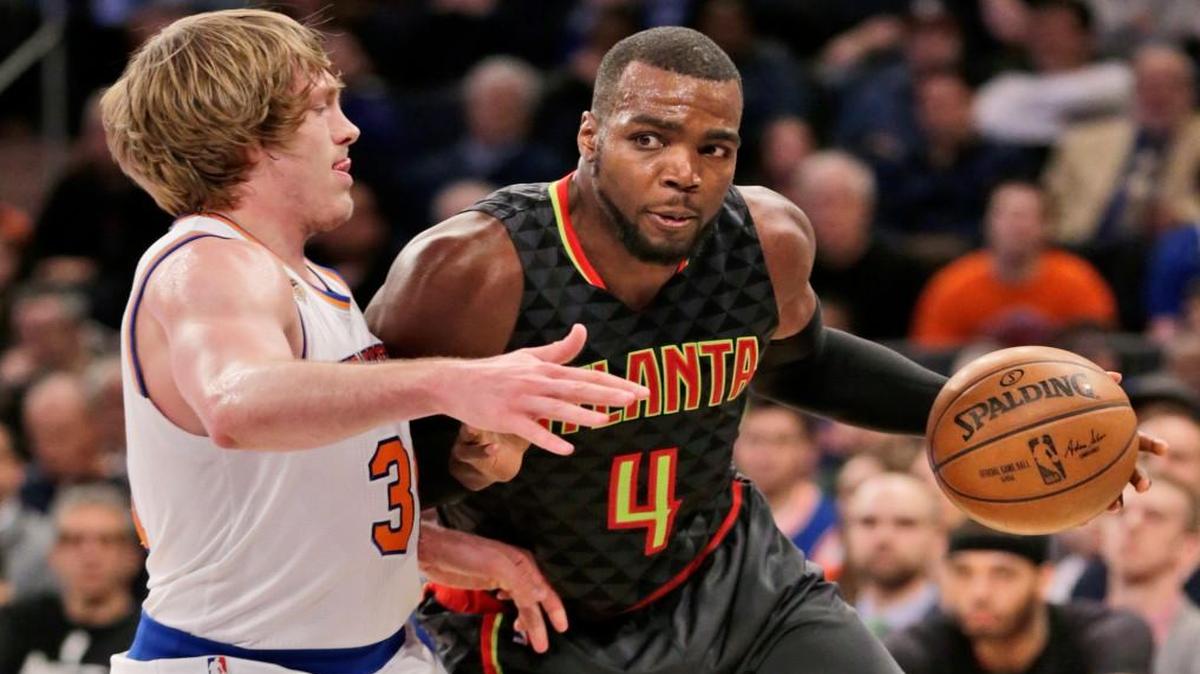 Atlanta’s Paul Millsap, right, pushes past New York’s Ron Baker during the second half Monday in New York. Baker, from Wichita State, made his frist career NBA start.