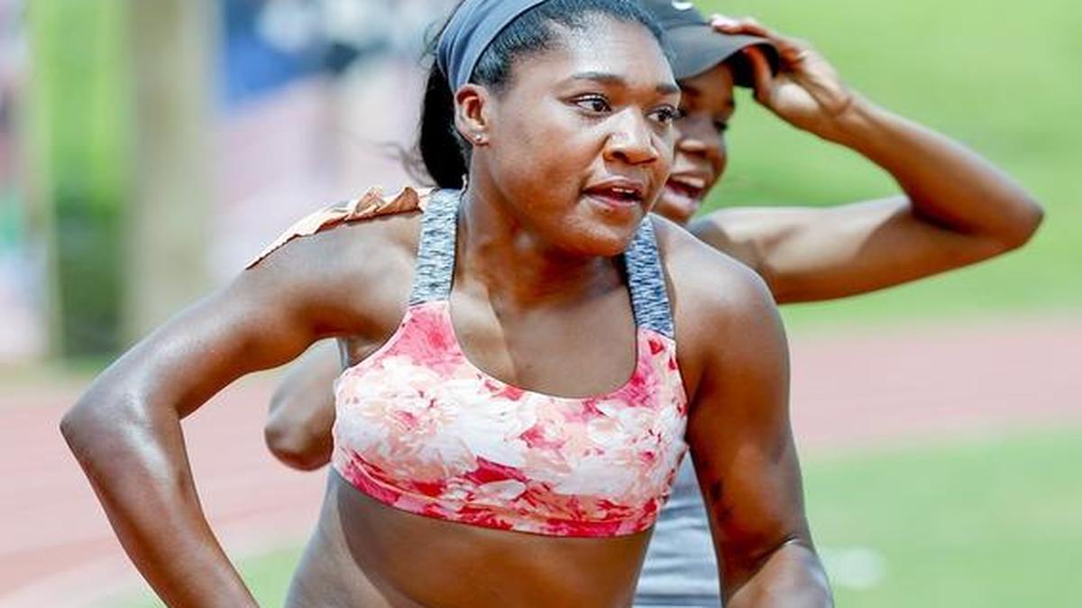 
WSU sprinter Deja Young, front, practices the baton handoff with teammate Shanice Andrews. A dislocated right shoulder at birth makes Young run with an unusual arm angle.
