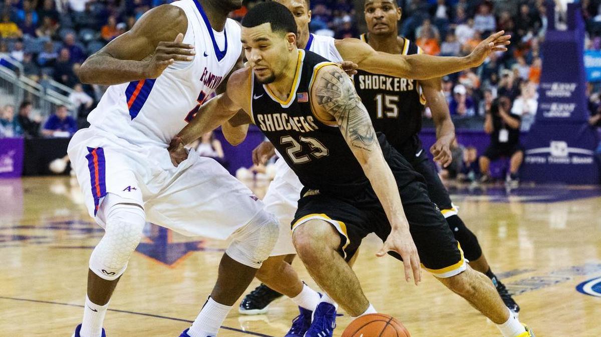 Wichita State's Fred Vanvleet (23) drives the ball through Evansville’s Willie Wiley (23) and Jaylon Brown (3) in the second half of Sunday’s game in Evansville, Ind. VanVleet scored a career-high 32 points.