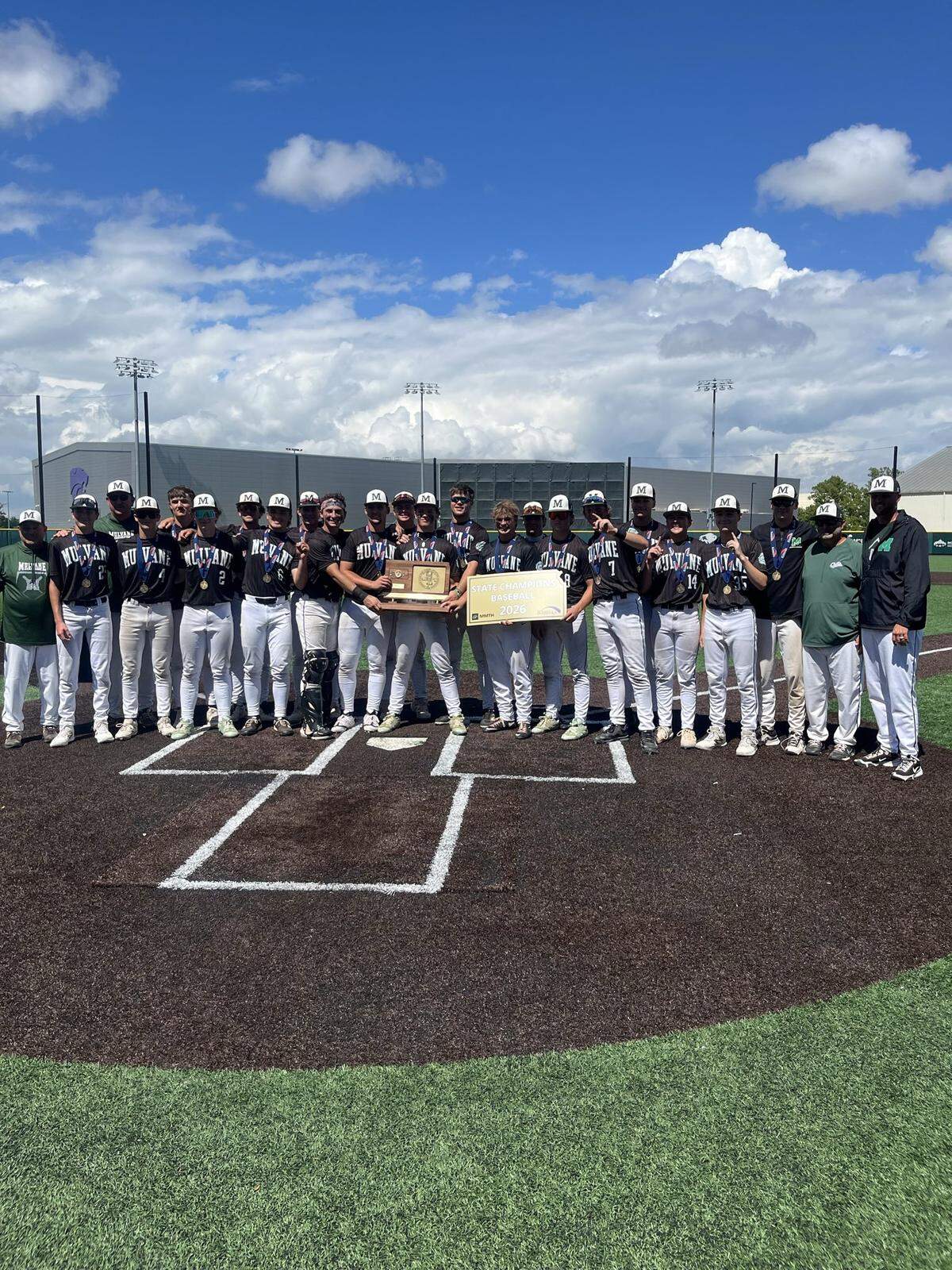 Mulvane baseball players pose with the trophy after defeating Topeka Hayden 9-4 to win the Class 4A state championship on Friday at Tointon Family Stadium in Manhattan. It was the Wildcats’ second state title in program history and first since 1986.